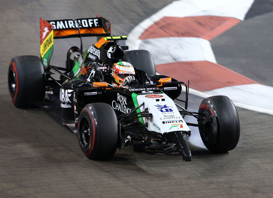 Sergio Perez rounds a corner with his front wing trapped underneath his Force India