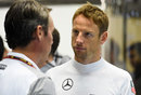 Jenson Button talks in the McLaren garage
