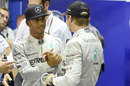 Lewis Hamilton is congratulated on pole by Nico Rosberg