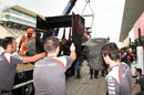 Esteban Gutierrez's Sauber returns to the pits on a truck after his accident in FP2