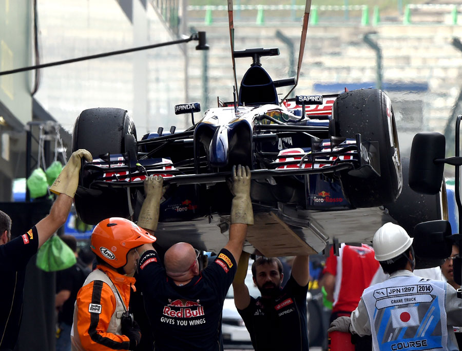 Jean-Eric Vergne's Toro Rosso is returned to the pits after stopping in FP2