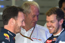 Christian Horner, Helmut Marko and Sebastian Vettel share a laugh in the garage after Red Bull's huge driver announcement on Saturday morning