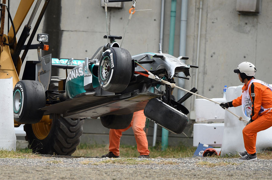 Lewis Hamilton's damaged car is towed away after his FP3 crash