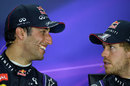 Daniel Ricciardo talks to team-mate Sebastian Vettel in the post-race press conference