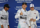 Nico Rosberg acknowledges the crowd with Lewis Hamilton and Valtteri Bottas watching on
