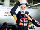 Daniil Kvyat puts on his helmet in the garage