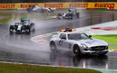 The two Mercedes drivers follow the safety car on lap one of the grand prix