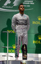 A subdued Lewis Hamilton watches on during the British national anthem