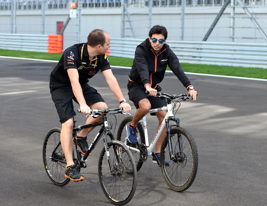 Force India's Sergio Perez and race engineer Gianpiero Lambiase cycle the Sochi circuit