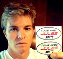 Nico Rosberg holds up the stickers drivers will wear on their helmets in support of Jules Bianchi