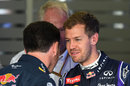 Christian Horner and Sebastian Vettel share a smile in the garage