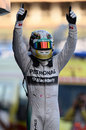 Lewis Hamilton celebrates his victory in parc ferme