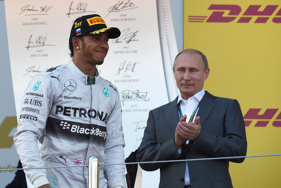Russian president Vladimir Putin applauds race-winner Lewis Hamilton on the podium