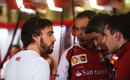 Fernando Alonso talks to his team in the garage