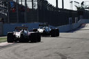 Kimi Raikkonen chases Nico Rosberg out of the final corner