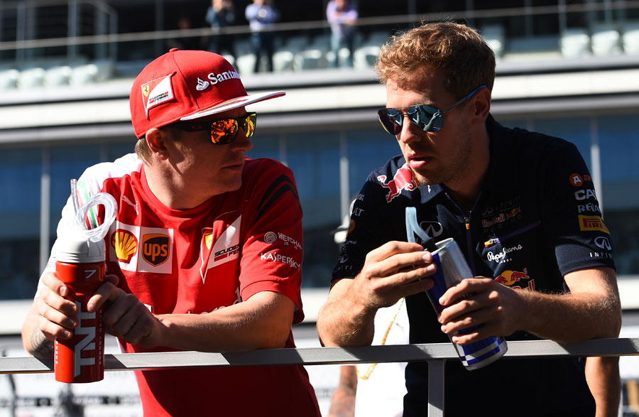Kimi Raikkonen chats to Sebastian Vettel on the drivers' parade