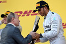 Russian president Vladimir Putin hands the trophy to race-winner Lewis Hamilton