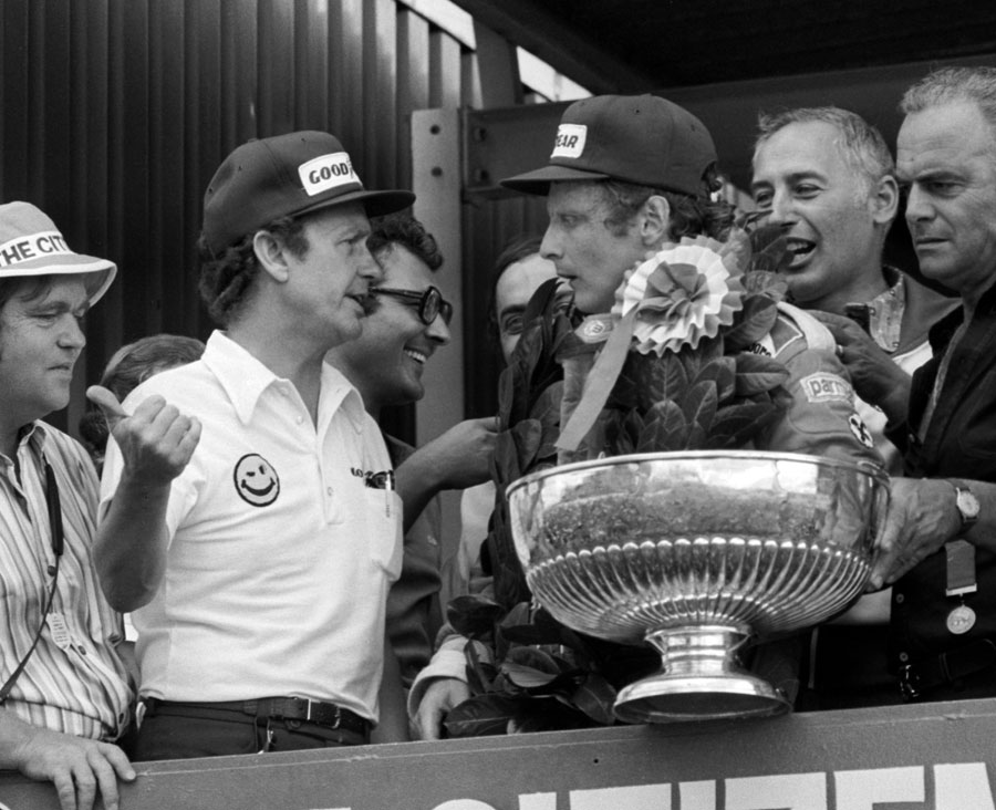 Niki Lauda is informed of Tom Pryce's fatal accident on the podium