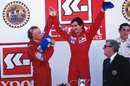 1984 champion Niki Lauda celebrates with Alain Prost after beating him to the title by half a point