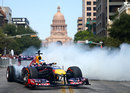 Sebastian Vettel wows crowds in the centre of Austin by pulling donuts in his Red Bull