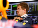 Sebastian Vettel looks on in the Red Bull garage during Friday practice