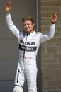 Nico Rosberg acknowledges the fans in parc ferme after claiming his ninth pole of the season