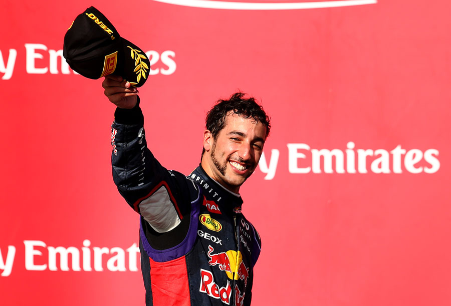 Daniel Ricciardo acknowledges the crowd on the podium after finishing third