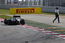 Adrian Sutil walks from his stricken Sauber after being punted out of the race by Sergio Perez