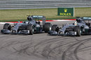 Lewis Hamilton passes Nico Rosberg on the inside of Turn 12