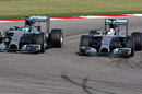 Lewis Hamilton passes Nico Rosberg on the inside of Turn 12