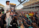 Lewis Hamilton celebrates victory with the fans on the main straight