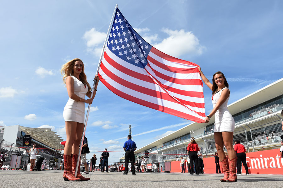 Grid girls hold up the American flag before the race 