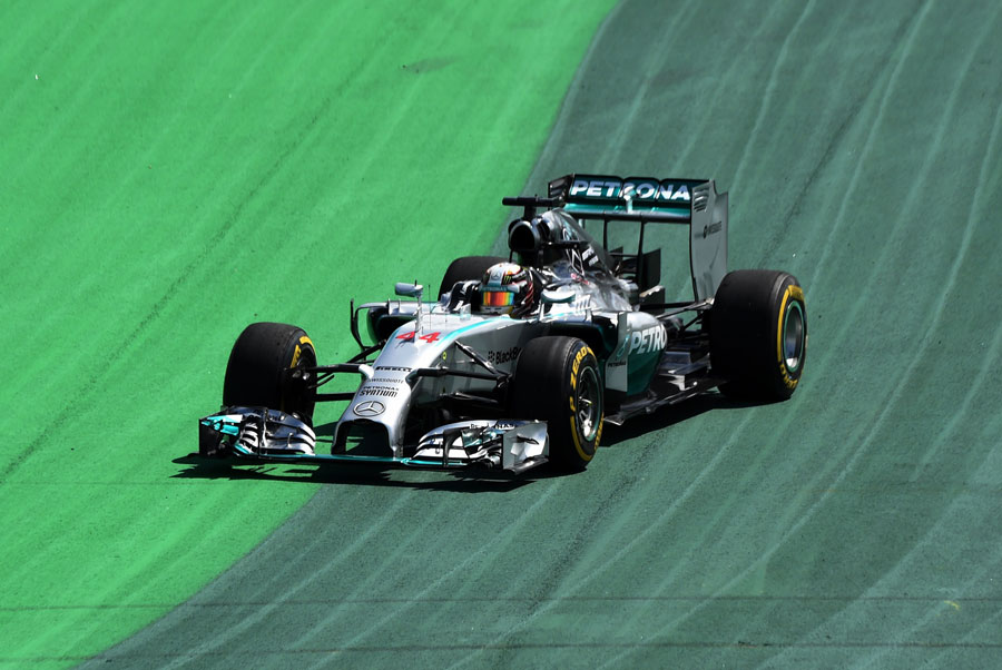 Lewis Hamilton runs across the asphalt at Turn 1 on Friday afternoon