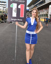 A grid girl stands next to Sergio Perez's number