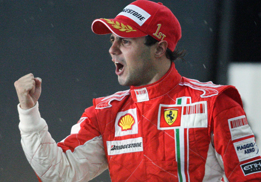 Race-winner Felipe Massa acknowledges the crowd despite losing the championship