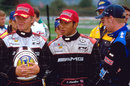 Team-mates Nico Rosberg and Lewis Hamilton talk with competitors before a karting heat