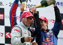 Sebastian Vettel sprays race-winner Lewis Hamilton on the podium
