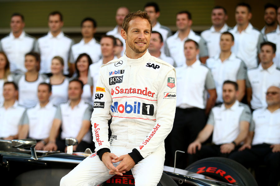 Jenson Button poses for an end-of-season McLaren team photo in the pit lane
