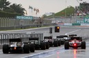 Cars queue at the end of a wet pit lane for qualifying 2