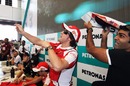 Fernando Alonso and Karun Chandhok throw paper aeroplanes at an autograph session
