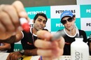 Karun Chandhok and Bruno Senna sign the camera at an autograph session