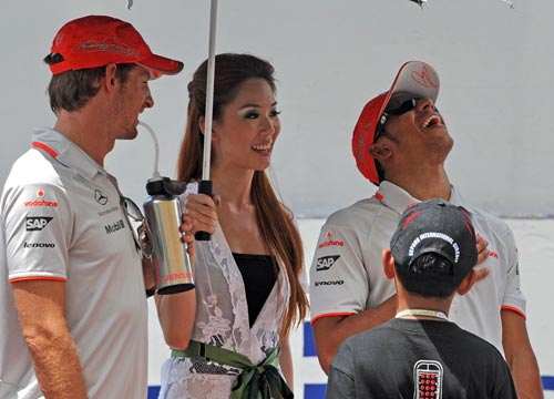 Lewis Hamilton and Jenson Button share a joke on race day