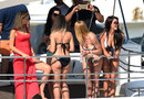 Girls watch the action of Friday practice from the luxury of a yacht  