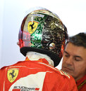 Fernando Alonso wears his farewell Ferrari helmet, covered in signatures of all the team's employees and the colours of the Italian flag