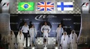 World champion Lewis Hamilton stands atop the podium