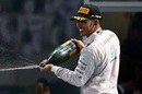 World champion Lewis Hamilton celebrates with champagne after the Abu Dhabi Grand Prix