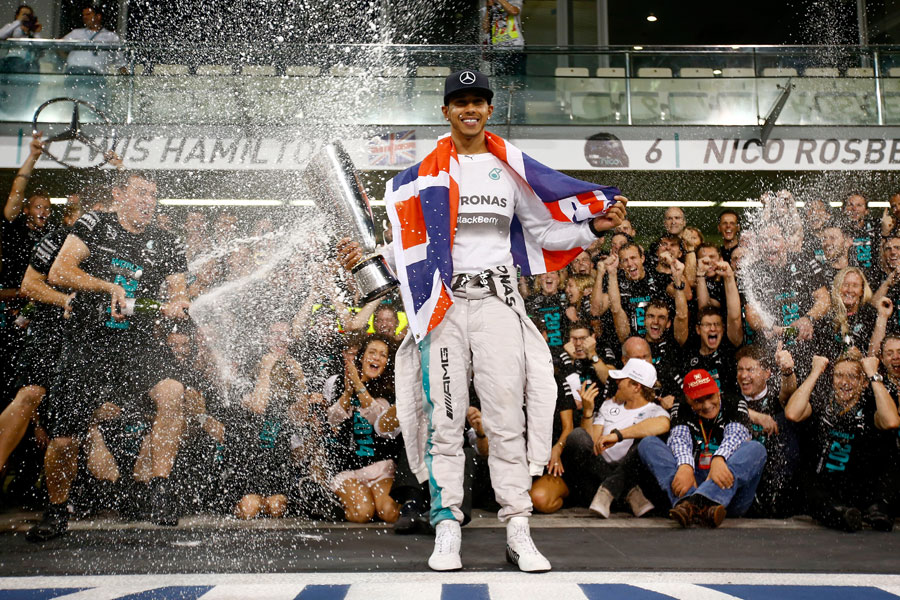 Lewis Hamilton is doused in champagne as he celebrates his second world championship