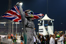 Lewis Hamilton celebrates with the British flag in parc ferme