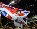 Lewis Hamilton celebrates his title triumph with the British flag