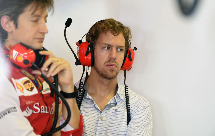 Sebastian Vettel watches on in the Ferrari garage
